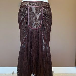 Bebe brown Lacey Skirt with small train detail in back. Size XS.